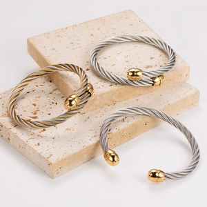 Three minimalist stainless steel twisted cable bangles in gold and silver finish