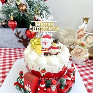 Detailed Christmas cake decoration set with Merry Christmas toppers and a wooden train