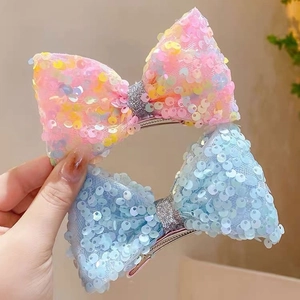 Sparkly sequin mermaid style bow hair clips for girls in pink and blue net fabric