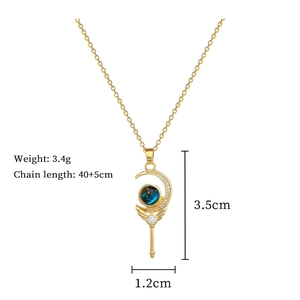 Macro detail of gold magic wand necklace with blue gemstone and dimensions 3.5cm x 1.2cm