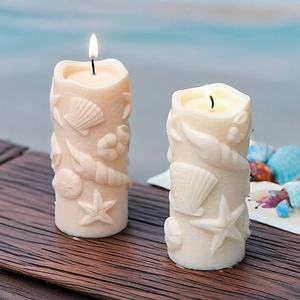Marine themed cylindrical relief candles featuring seashell and starfish patterns
