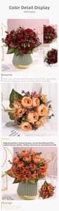 Close-up of artificial burgundy, yellow and orange peony silk flowers in a striped vase