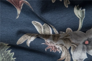 Macro shot of vintage floral print fabric on dark blue cotton polo shirt