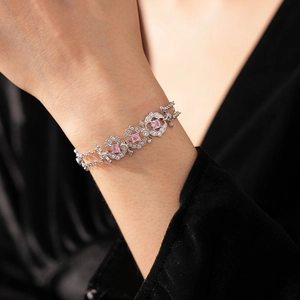 Detail of vintage palace style silver bracelet with square pink gemstone on wrist