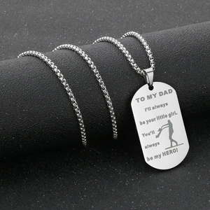 Macro shot of stainless steel dog tag necklace with engraved To My Dad tribute message