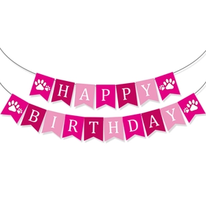 Detailed view of pink paper Happy Birthday banner with white letters and cute paw prints