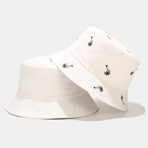 White cotton bucket hats featuring minimalist plain design and green palm tree embroidery