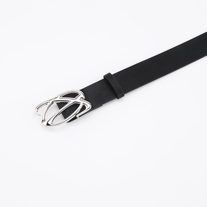 Close-up of black leather belt with silver buckle and smooth textured finish