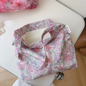 Detail view of floral cotton shoulder bag showing magnetic closure and interior lining