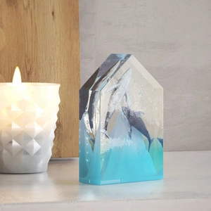 Macro view of house-shaped crystal mold featuring a 3D ocean whale art piece