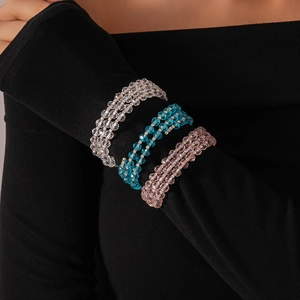 Close-up of a three-layered faceted glass bead bracelet in blue, pink, and white tones