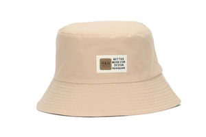 Detail view of the light khaki cotton bucket hat with woven label and reinforced stitching