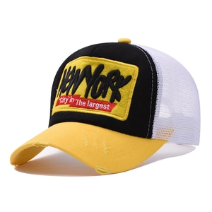 Close-up of NEW YORK trucker hat featuring distressed yellow brim and white mesh detail