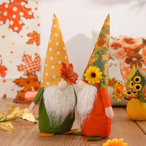 Pair of autumn harvest gnomes with maple leaf hats and sunflowers for Thanksgiving decor