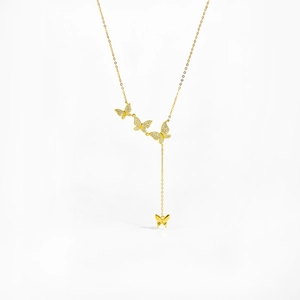 Detail shot of golden butterfly necklace with sparkling white cubic zirconia stones