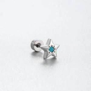 Silver star stud earring with green turquoise bead inlay on a textured background