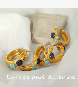 Close-up of 18k gold-plated C-shaped hoop earrings with blue and green natural stones