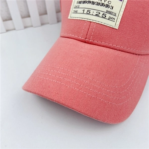 Close-up of pink canvas baseball cap showing detailed stitching and vintage NYC label