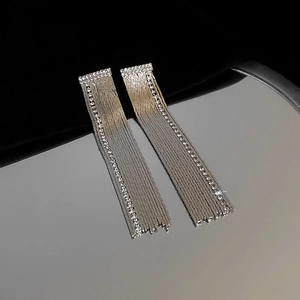Detailed close-up of sparkling square rhinestone tassels on elegant silver drop earrings