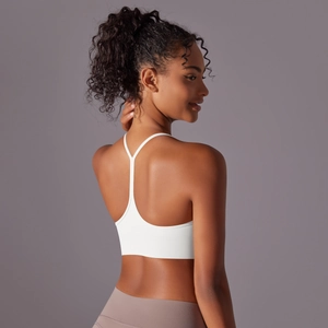 Detail of white sports bra with racerback straps and premium double-sided brushed fabric