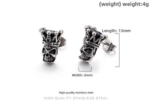 Macro view of vintage skull stud earrings with black gemstone and crown in steel