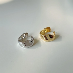 Detailed close-up of S925 silver ear clips with irregular molten texture in gold and silver