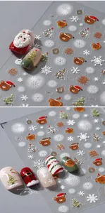 Detail of 3D embossed Christmas nail art stickers with Santa and gold snowflake patterns