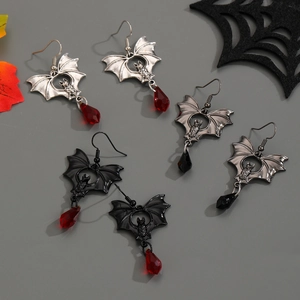 Macro detail of gothic bat earrings with teardrop gems in silver and black colors