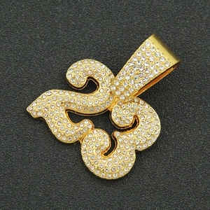 Macro close-up of golden iced-out number 23 pendant with shiny crystal rhinestones