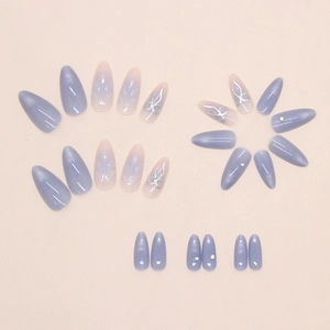 Detail of almond-shaped nails with purple gradient, silver bows and sparkling rhinestones