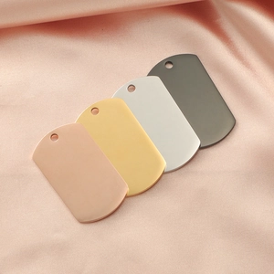 Polished stainless steel dog tags in gold silver rose gold and black on silk background