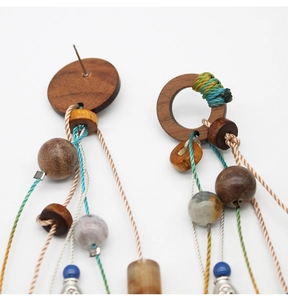 Detail shot of boho wood bead tassel earrings showing handcrafted textures and weave