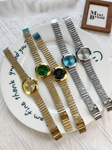 Collection of square quartz watches with colorful dials on a decorative white ceramic tray