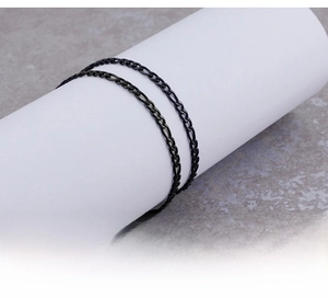 Close-up of minimalist black titanium steel NK chain with 3:1 figaro link texture