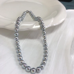 Close-up of blue-grey aurora pearl necklace with S925 silver clasp on white tray