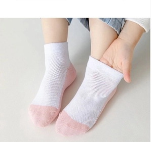 Close-up of stretchy white cotton mesh socks for girls with pink toe and heel details