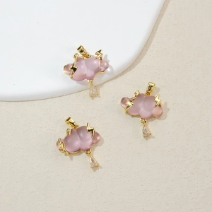 Detailed view of three purple resin cloud charms with gold lightning and water drop pendants
