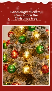 Close-up of glowing red, green and gold Christmas ornaments on snowy tree branches