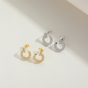 Minimalist C-shaped hoop earrings with sparkling pave-set stones in gold and silver
