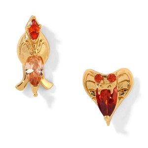 Macro detail of gold snake earring with heart red zircon and abstract drop stone