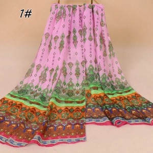 Detail of bohemian floral print chiffon scarf with vibrant green and orange patterns