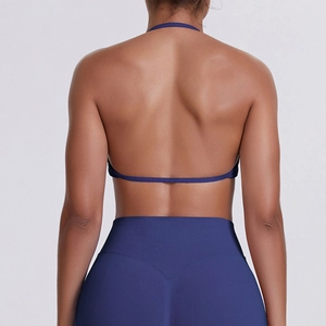 Detail of seamless open-back sports bra and high-waisted leggings in navy blue