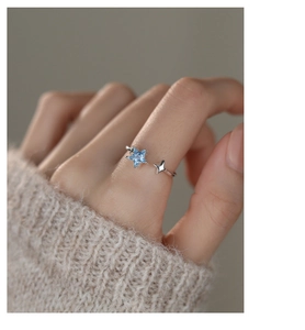 Close-up of S925 silver star ring featuring a sea blue zircon stone on finger
