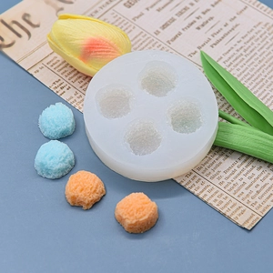 Macro detail of 4-cavity silicone mold with textured ball-shaped fondant decorations