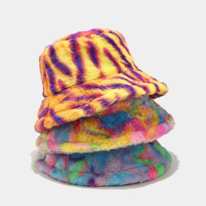 Stacked plush faux fur bucket hats featuring tiger stripes and tie-dye patterns