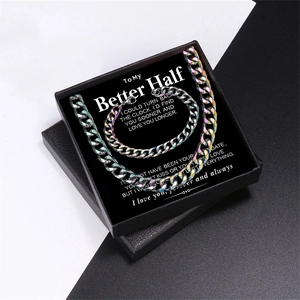Detailed view of iridescent Cuban link necklace and bracelet set in a black gift box