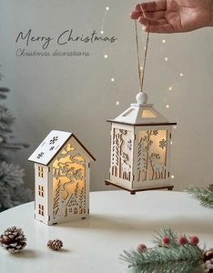 Detail of wooden Christmas LED lantern with reindeer cutout and warm glowing lights
