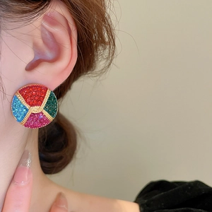 Macro shot of vintage round studs with colorful rhinestones and gold rope texture