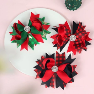 Three-piece Christmas hair bow set with reindeer print and rhinestones on a white tray