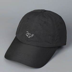 Detail of embroidered elephant logo on a black quick-dry lightweight baseball cap